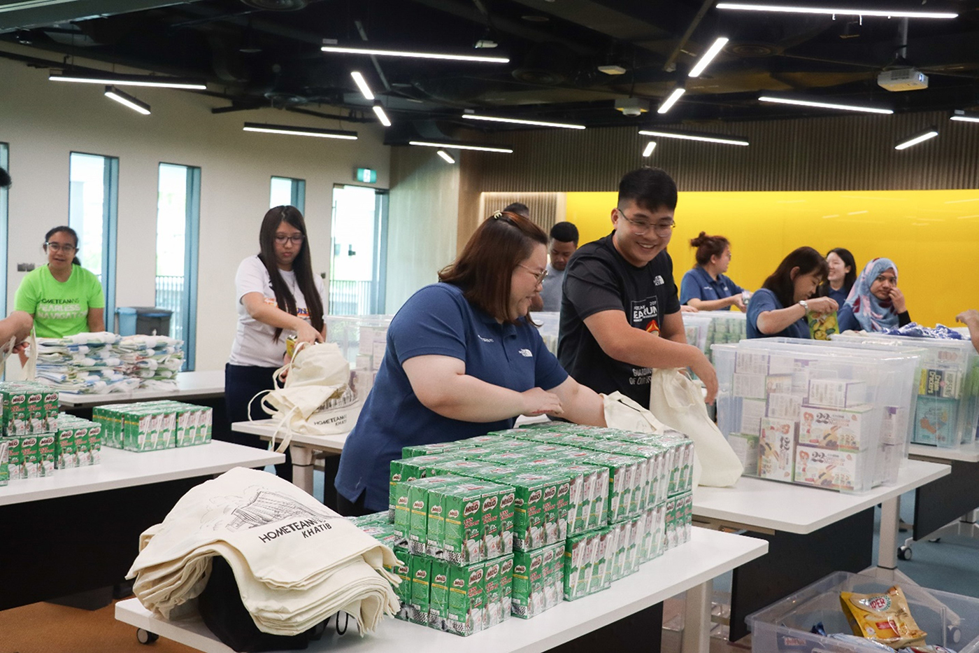 HomeTeamNS staff preparing care packages that were distributed to Yishun residents under the SWAMI Home Help Programme.