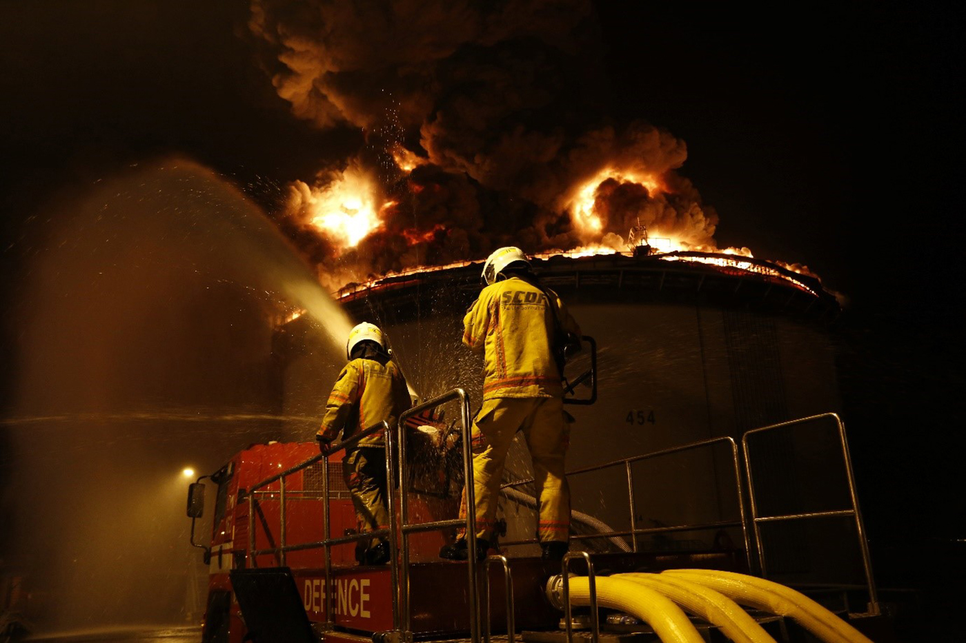 SCDF personnel fighting the oil storage tank fire at Pulau Busing.