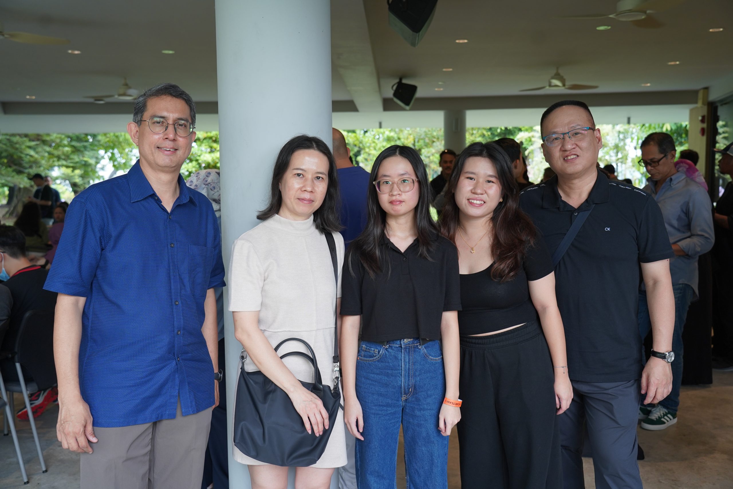 HomeTeamNS Children's Education Awards Recipient Hazel Tan (middle) with her family and HomeTeamNS President Mr Muhammad Faishal Ibrahim.