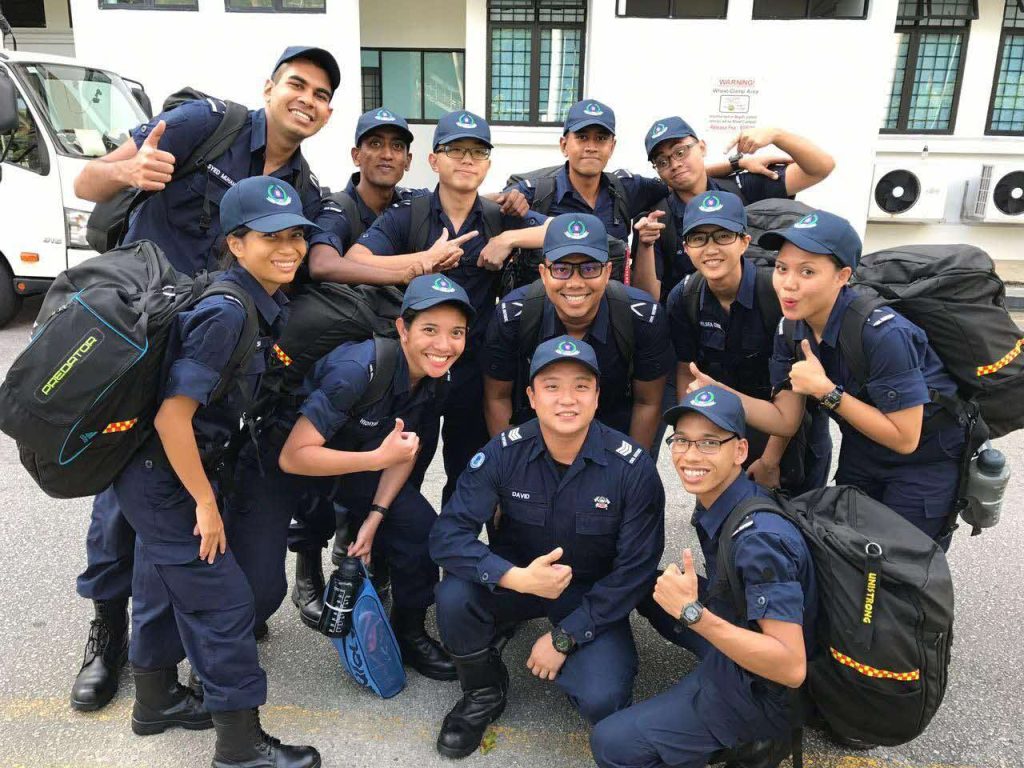 Nurhidayah (first row, second from left) with her batchmates and instructor at the Civil Defence Academy during their training.
