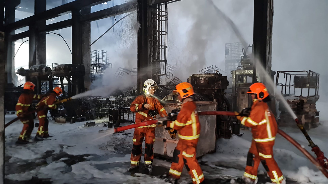 Kim Mun (in white helmet) working with his colleagues during a firefighting operation in Tuas in 2022.