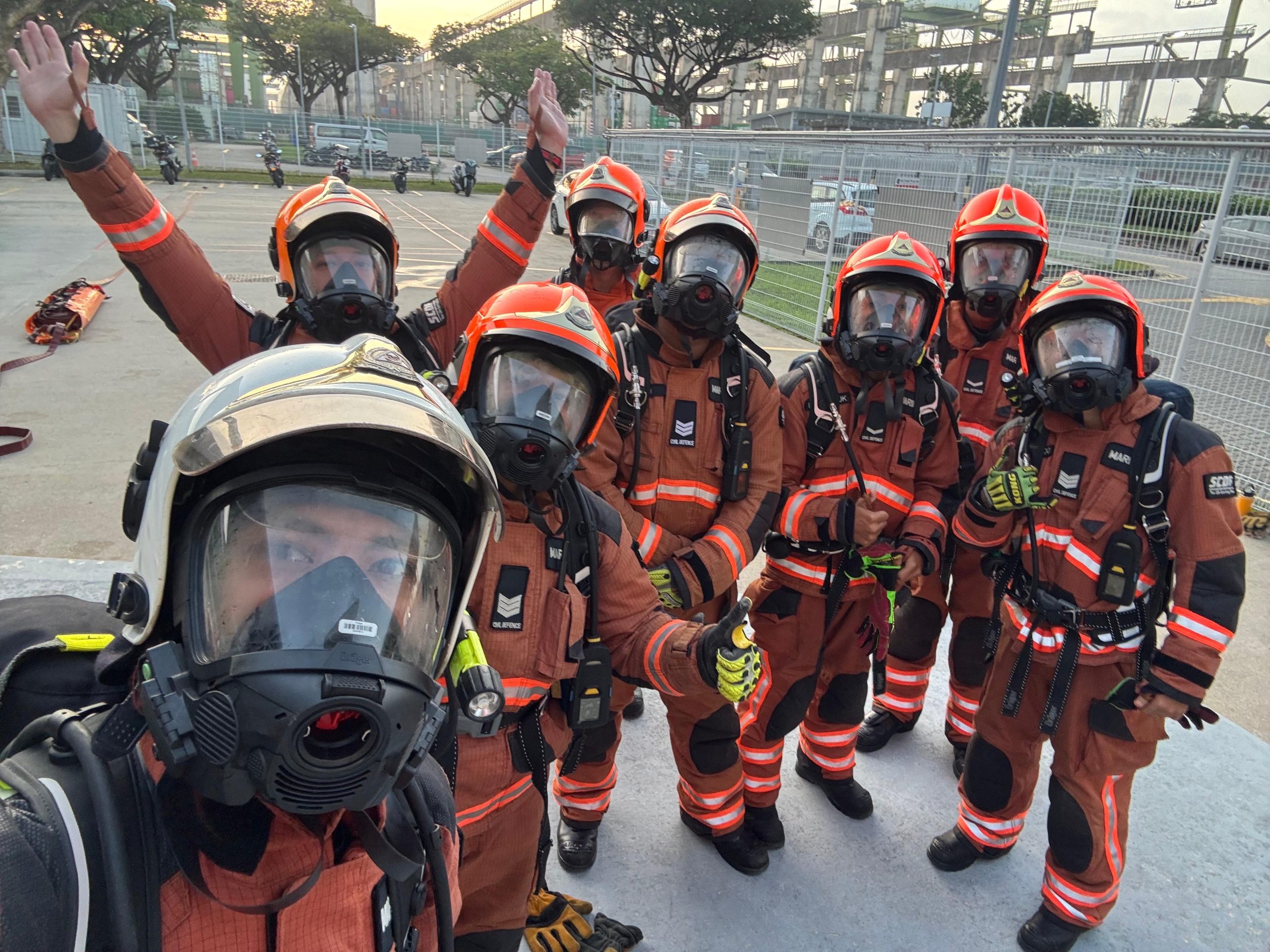 Naufal (second from left) with his team during a Breathing Apparatus (BA) endurance training session, which involved high-intensity drills such as hoisting weights and pulling stretchers while wearing full BA and face masks.