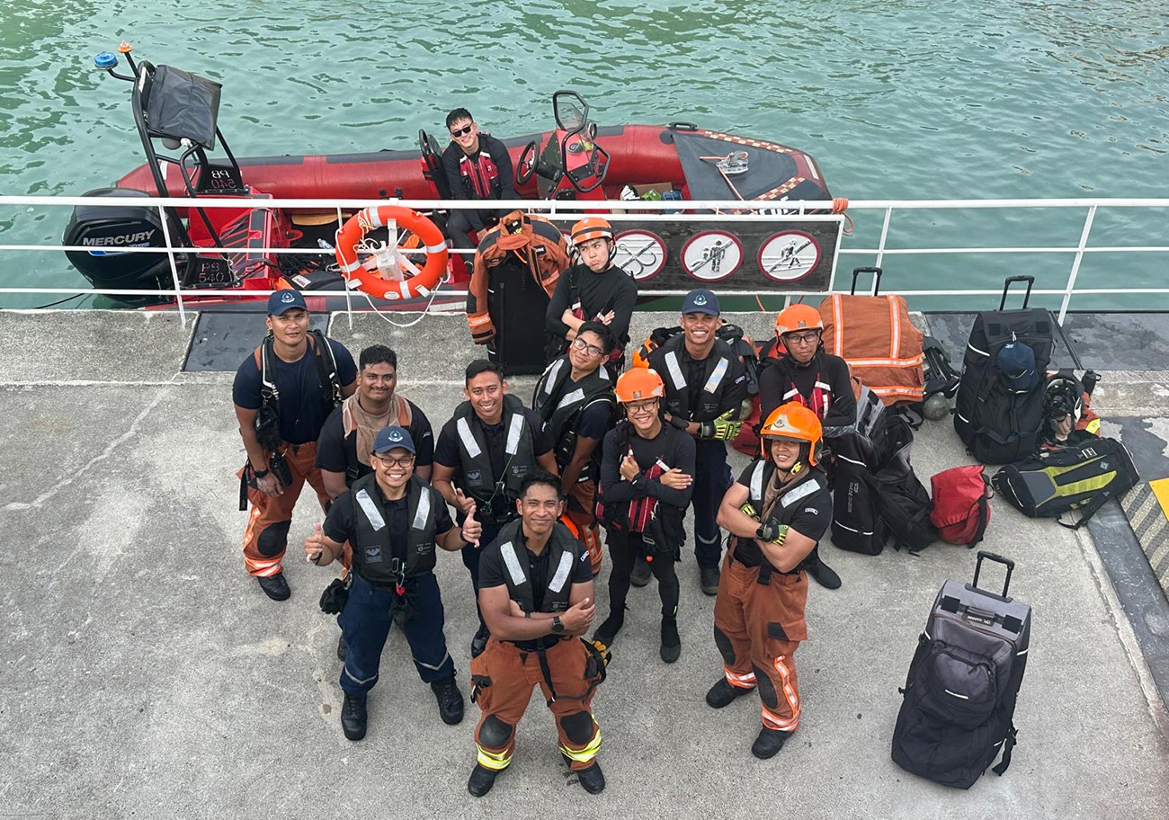 Naufal (second row, first from left, wearing a cap and spectacles) with his colleagues after completing a training exercise.