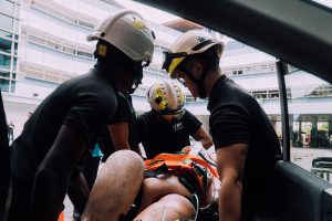 Anaqy (centre) taking part in training at Yishun Fire Station. He had to carefully extricate a casualty from a vehicle, putting his medical skills to the test.