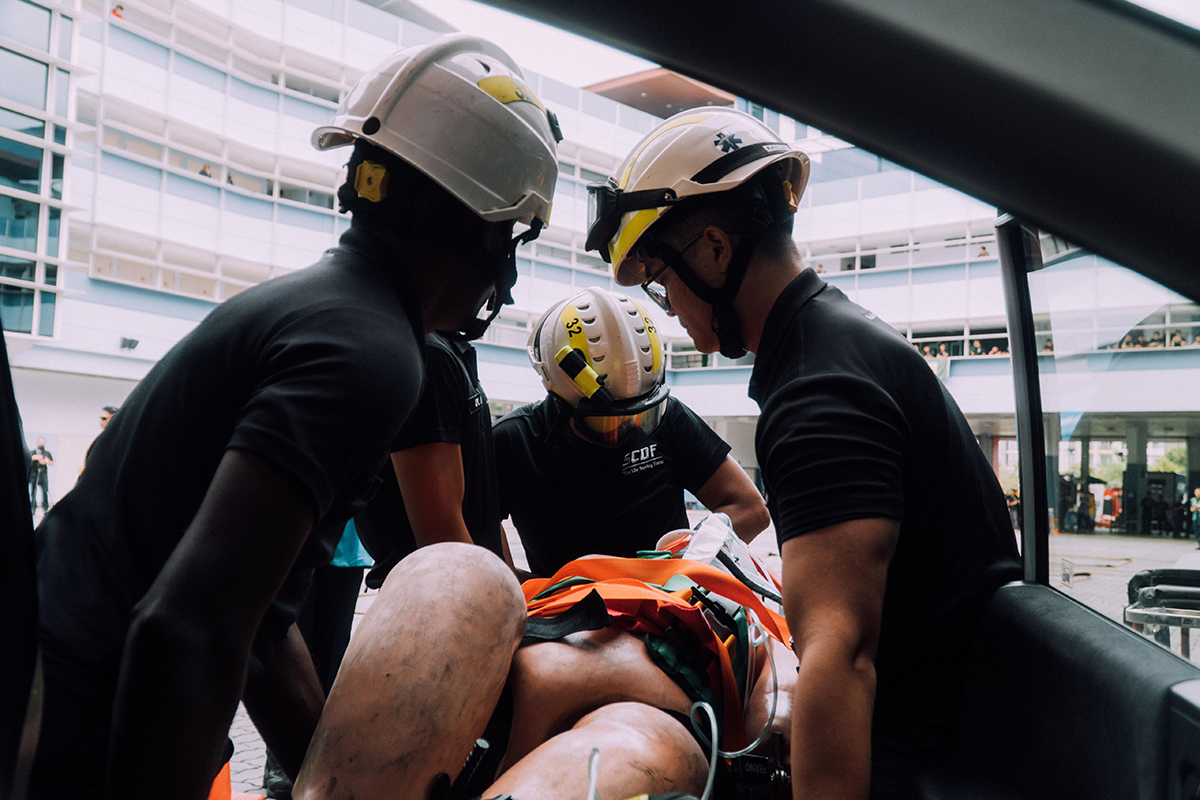 Anaqy (centre) taking part in training at Yishun Fire Station. He had to carefully extricate a casualty from a vehicle, putting his medical skills to the test.
