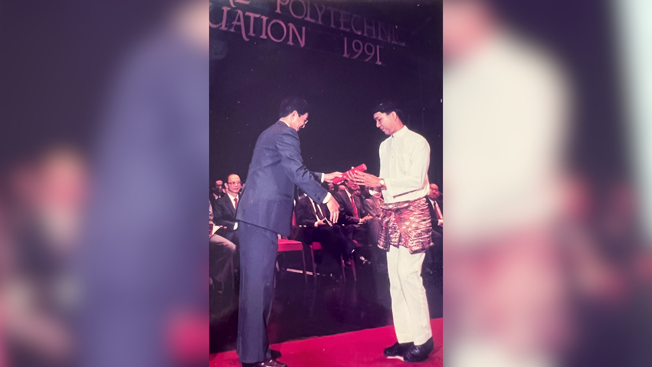 Azmi (right) receiving his Diploma in Mechanical Engineering from Singapore Polytechnic in 1991.