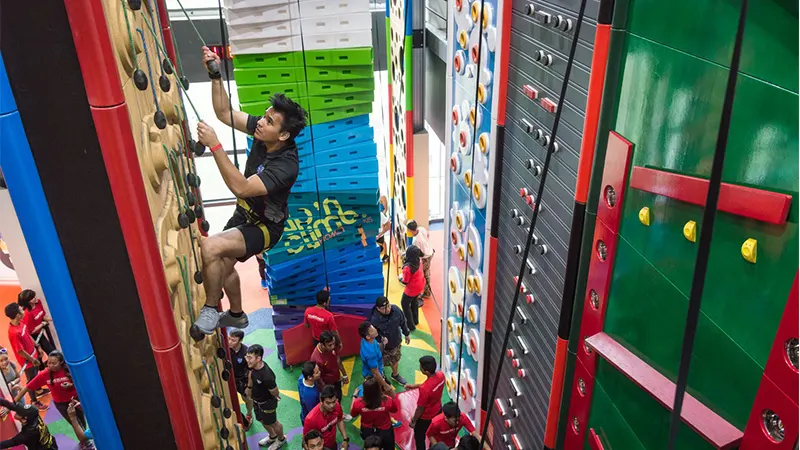 Image of NSmen trying out the climbing walls at Clip 'n Climb