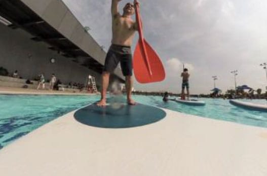A man doing stand up paddling