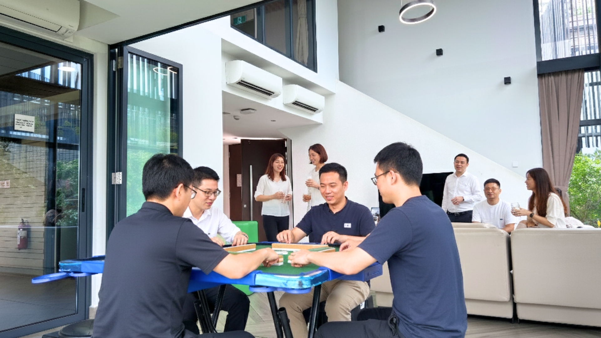 East Villa Corporate Sales 9 Corporate guests relaxing and playing mahjong in East Villa’s spacious living area.