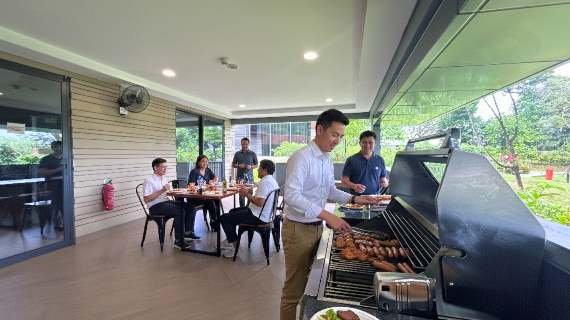 East Villa Corporate Sales 11 Corporate group dining and grilling at East Villa’s sheltered BBQ area overlooking greenery.