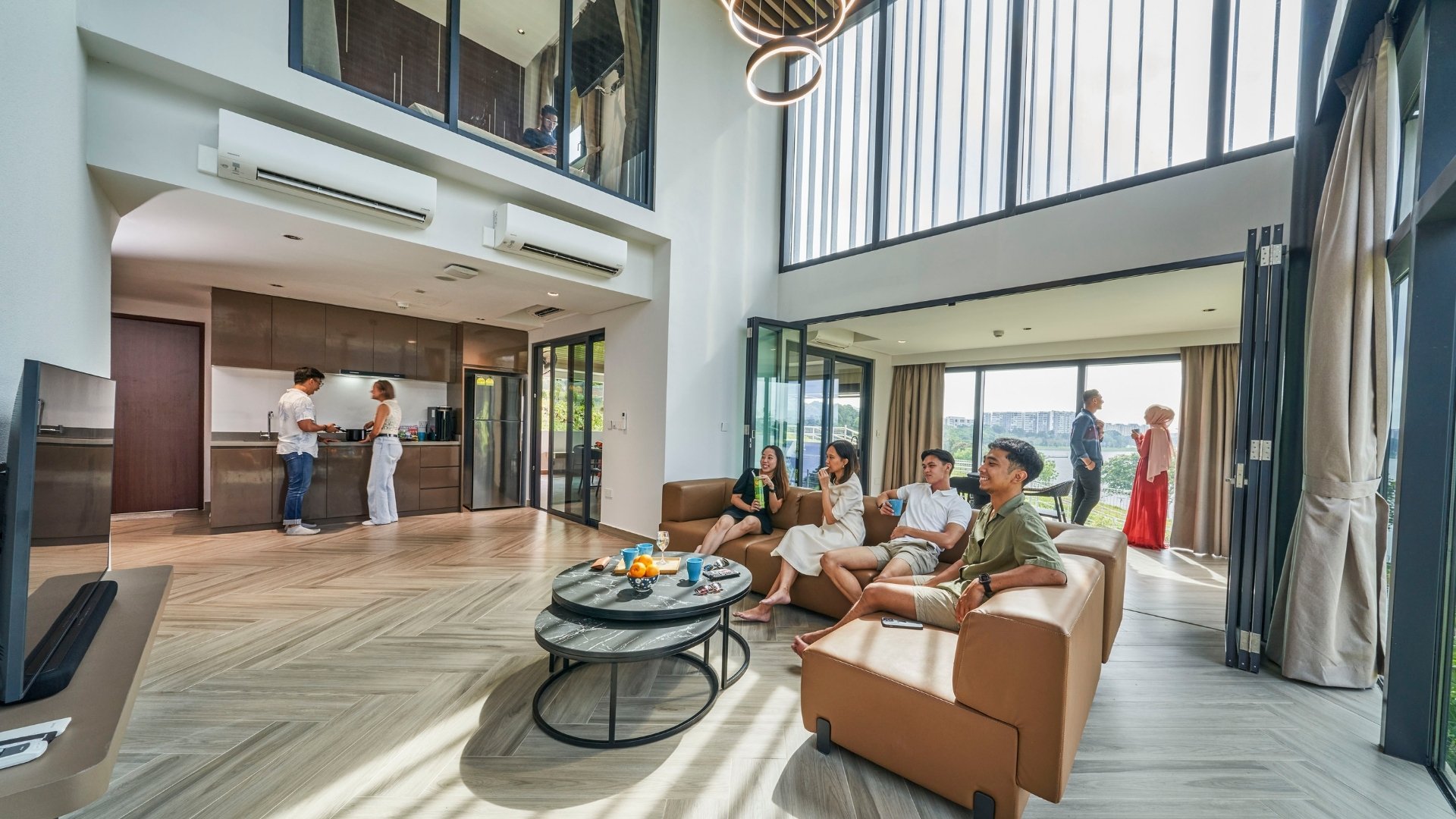 East Villa Corporate Sales 4 Corporate guests enjoying a casual meeting in East Villa’s spacious living room with modern amenities.